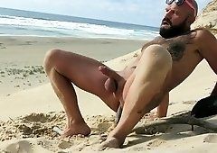 Hairy twins lick cock on beach