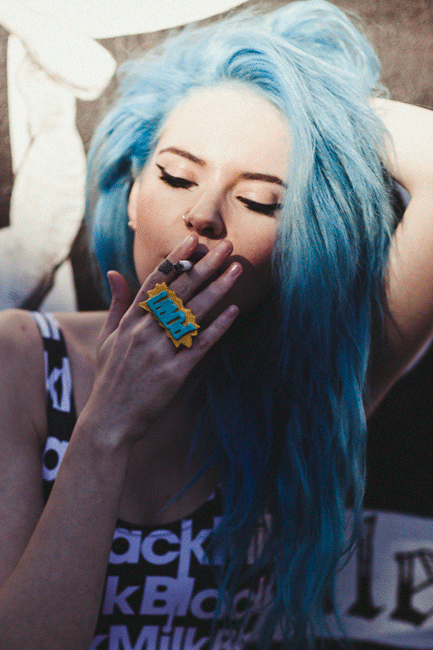 Girl smokes cigarette naked look